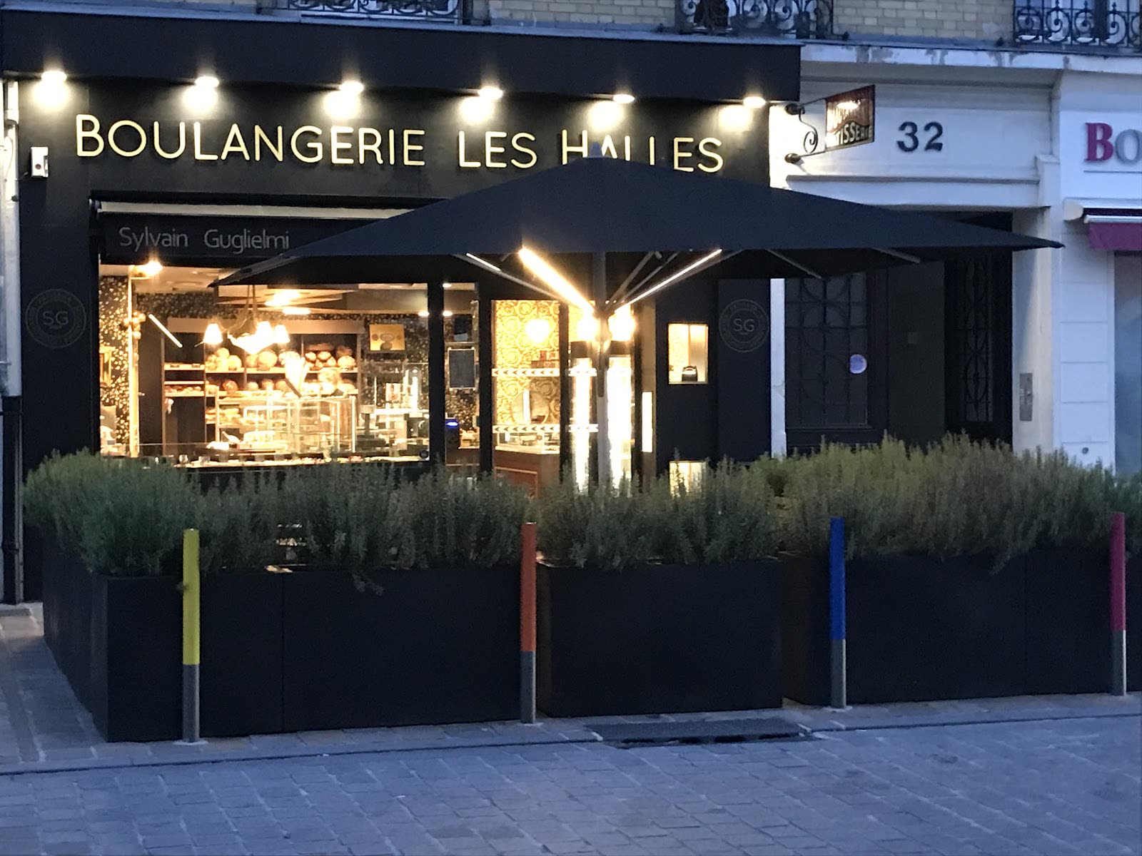 Façade illuminée de la Boulangerie Les Halles le soir, Rue de Mars à Reims